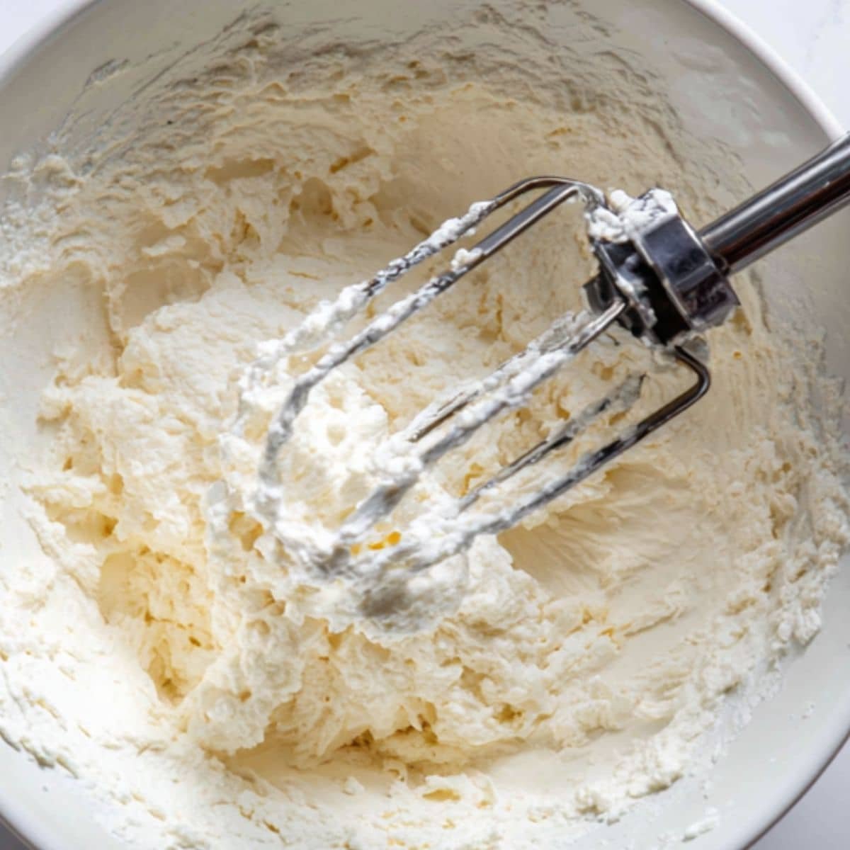Beating ricotta-cream cheese filling until smooth	