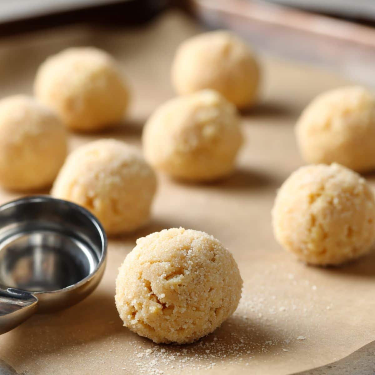 Shaped cookie dough balls on parchment ready to bake	
