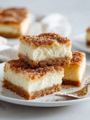 Close-up of sliced snickerdoodle cheesecake bars on white kitchen counter