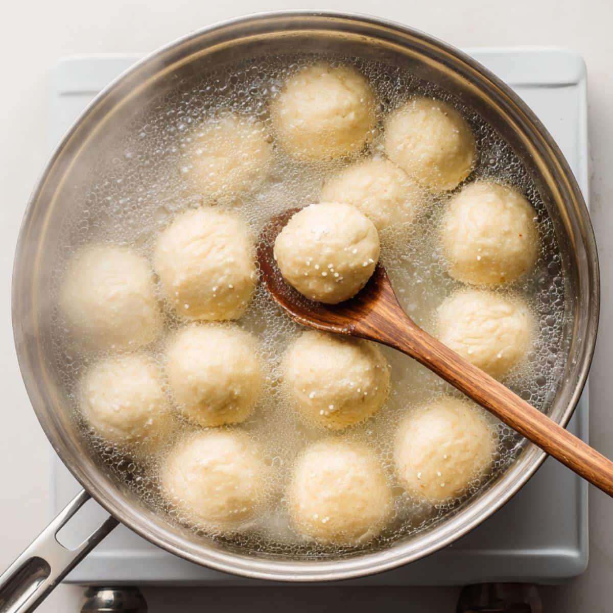Pretzel dough bites boiling in baking soda water	