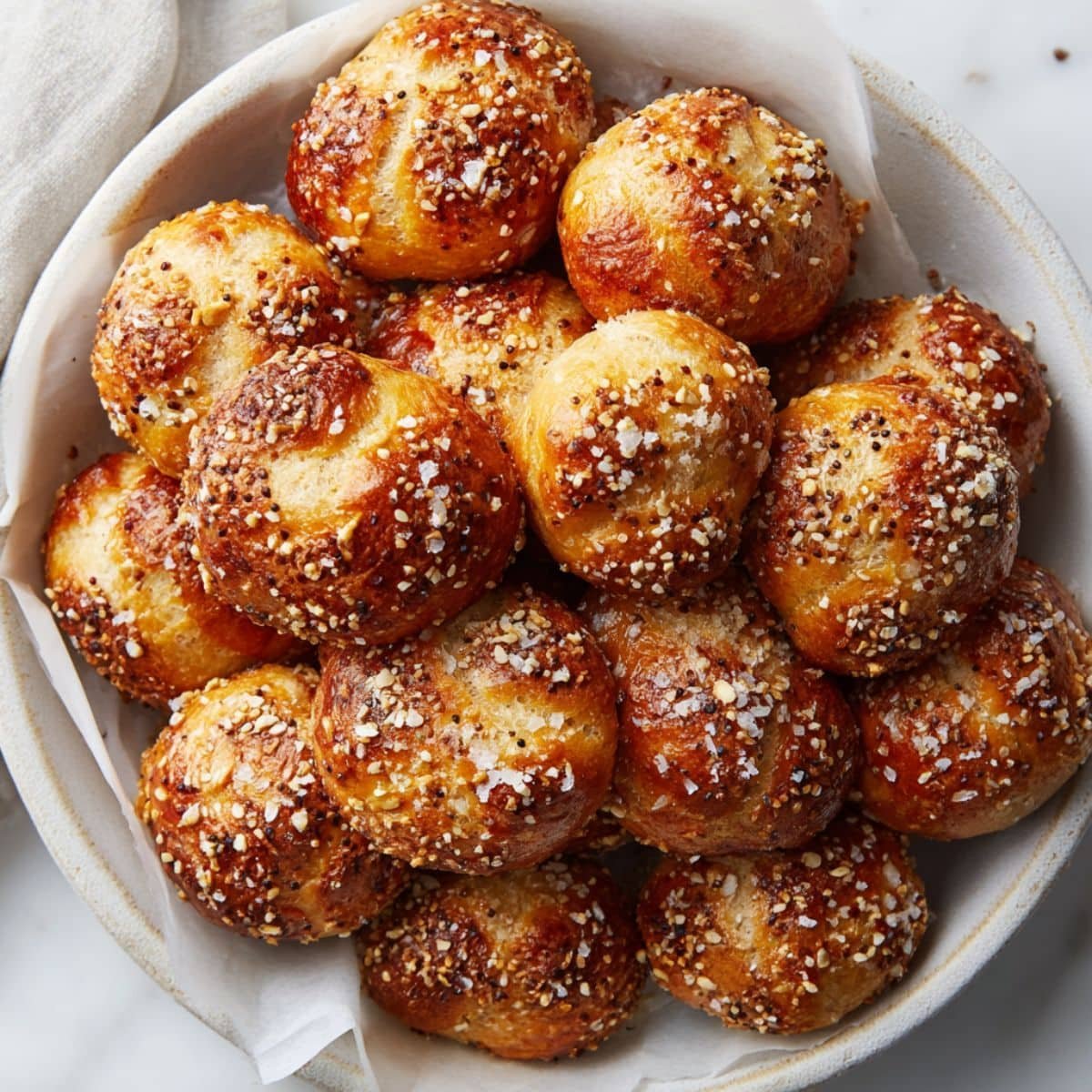 Homemade sourdough pretzel bites sprinkled with coarse salt and seasoning	