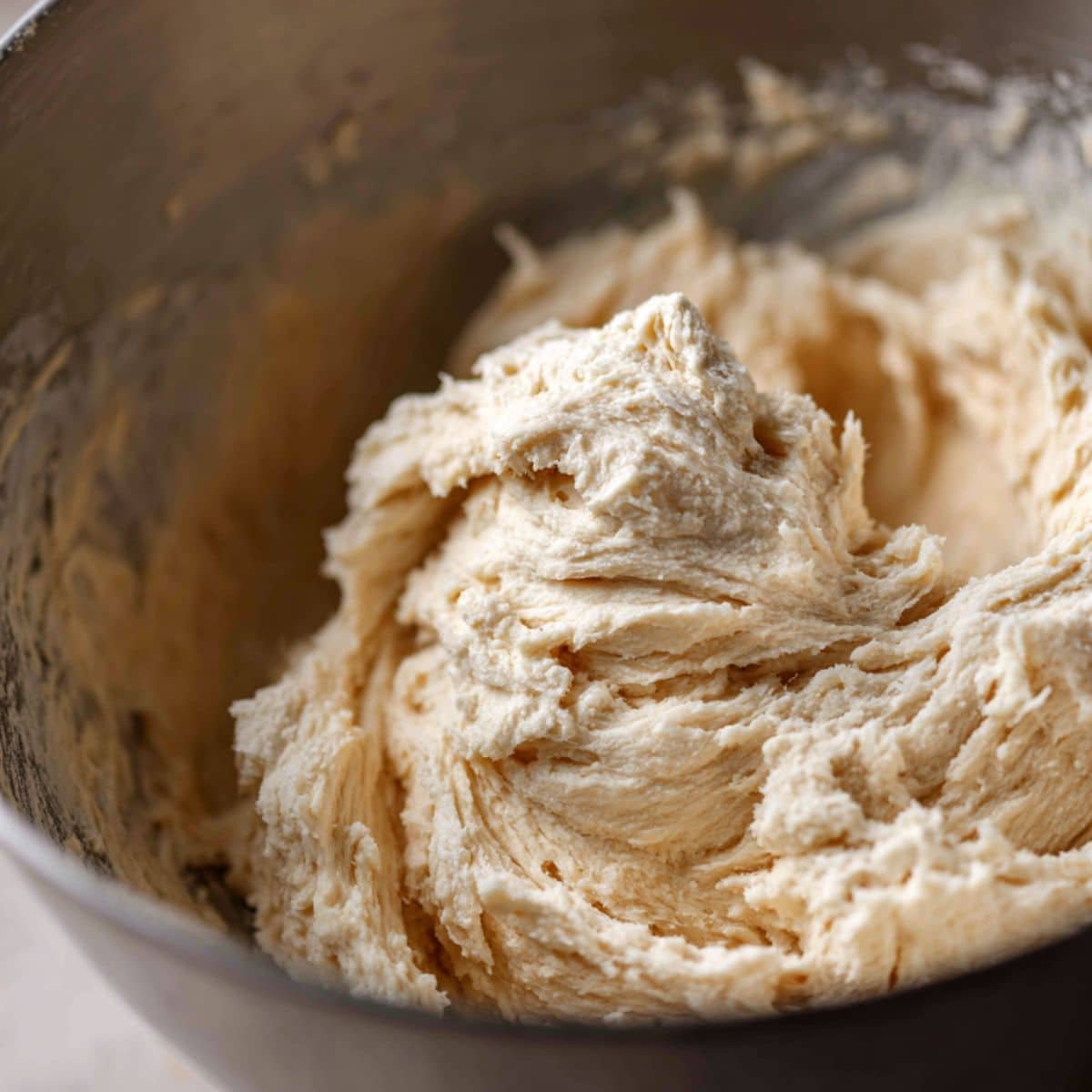 Mixing sourdough French bread dough in a large bowl	