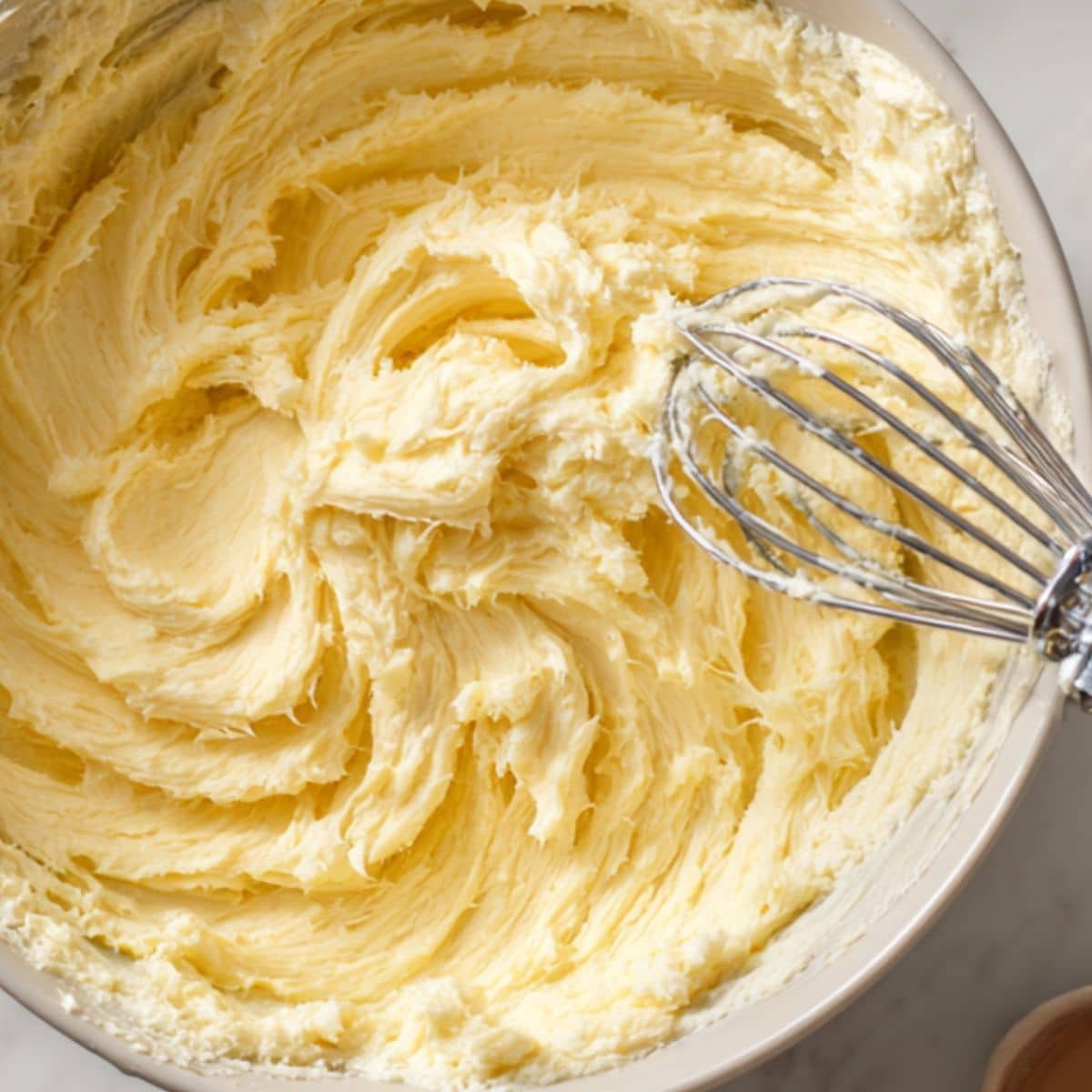 Creamed butter and sugar in a bowl during cookie prep