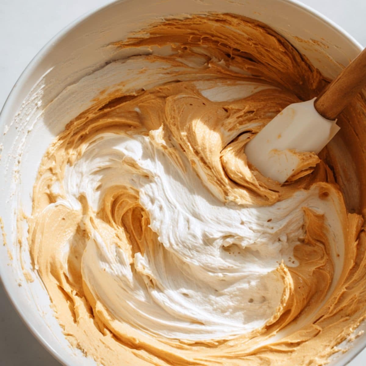 Mixing peanut butter cheesecake filling by hand	
