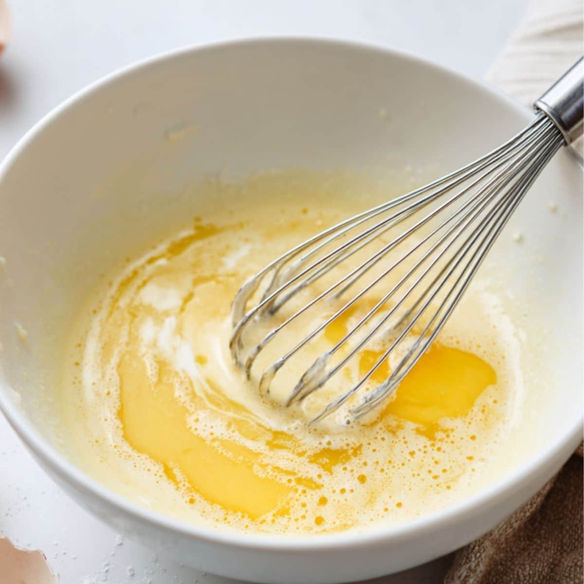 Wet ingredients being mixed in a bowl