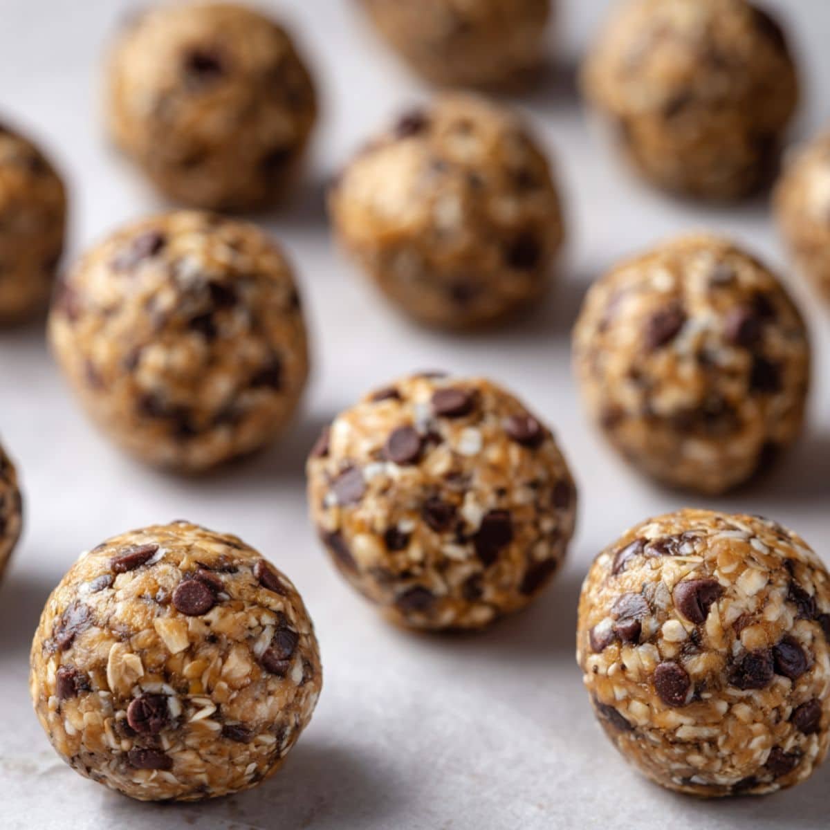 Rolled banana energy bites on tray ready to chill	