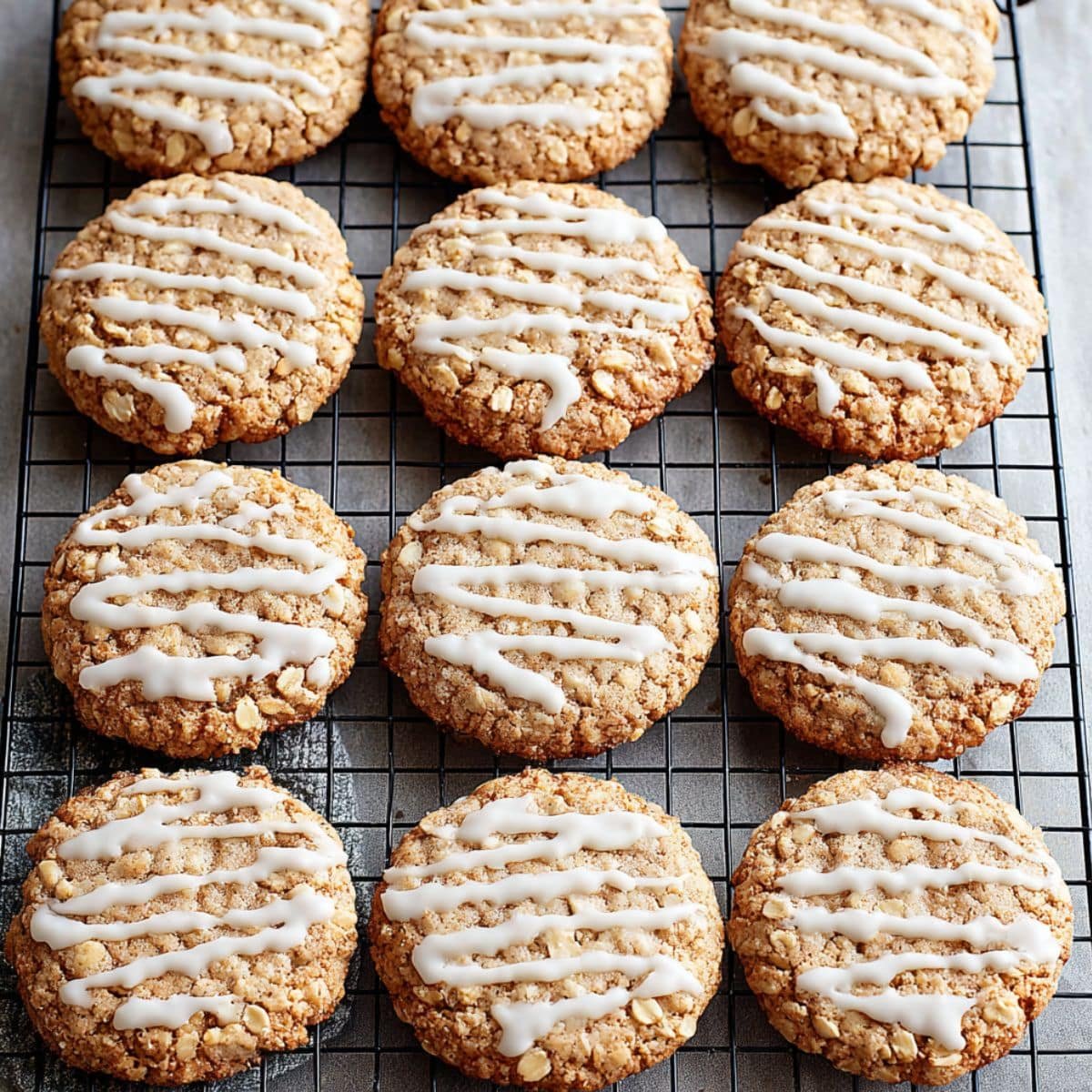 Dipping oatmeal cookie into homemade glaze frosting