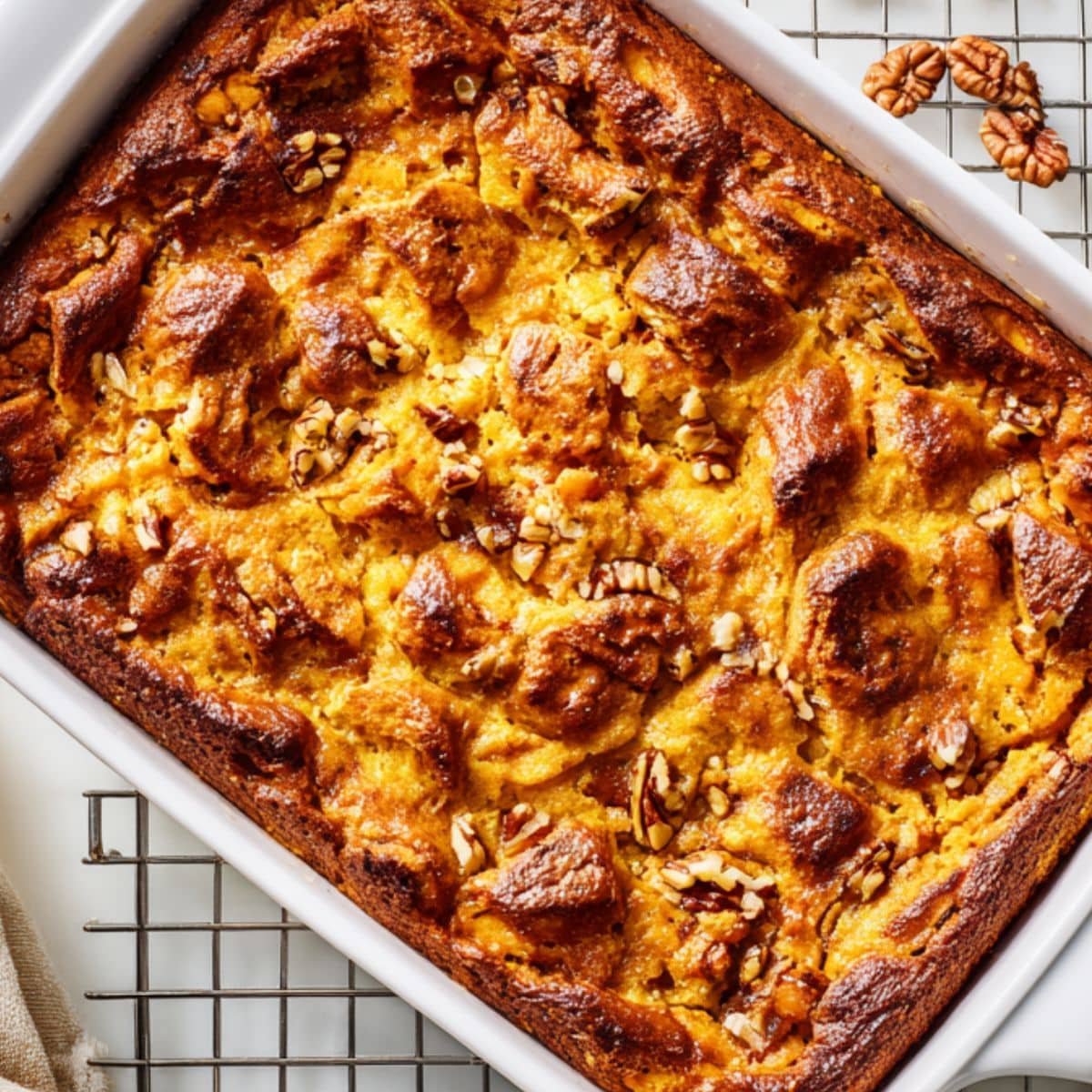 Freshly baked sweet-potato bread pudding cooling on rack	