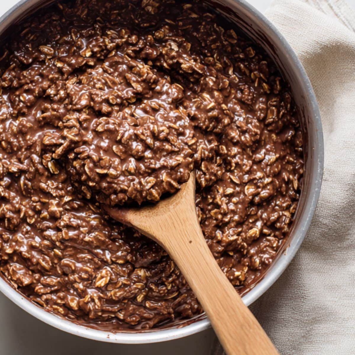 Mixing oats and peanut butter into chocolate base for no bake cookies