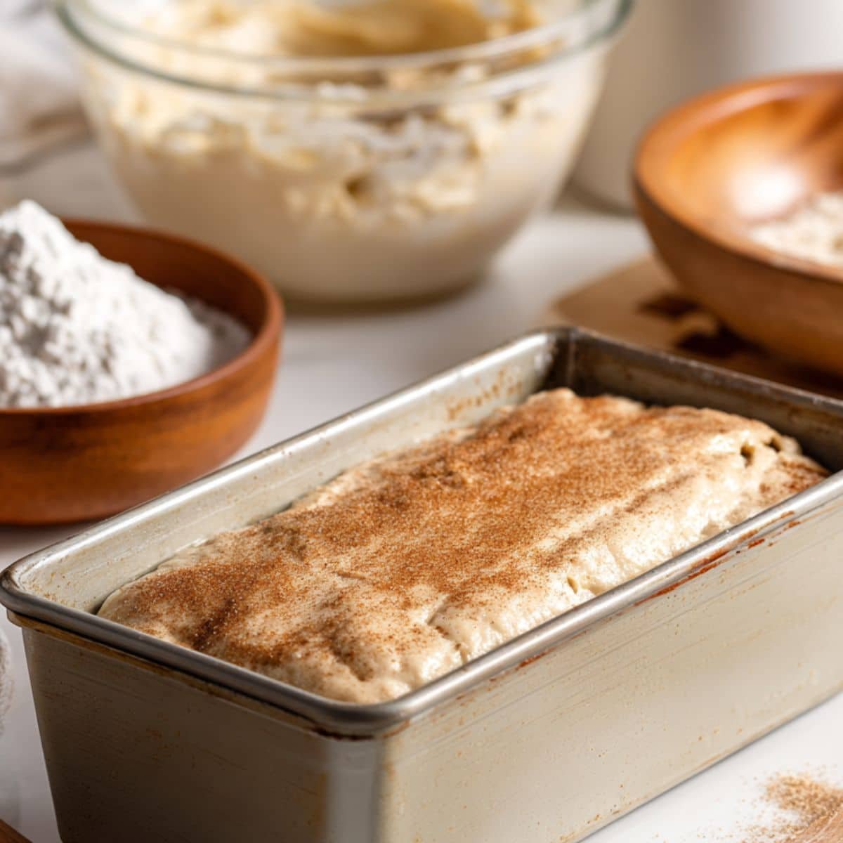 Layering batter and cinnamon sugar in loaf pan	