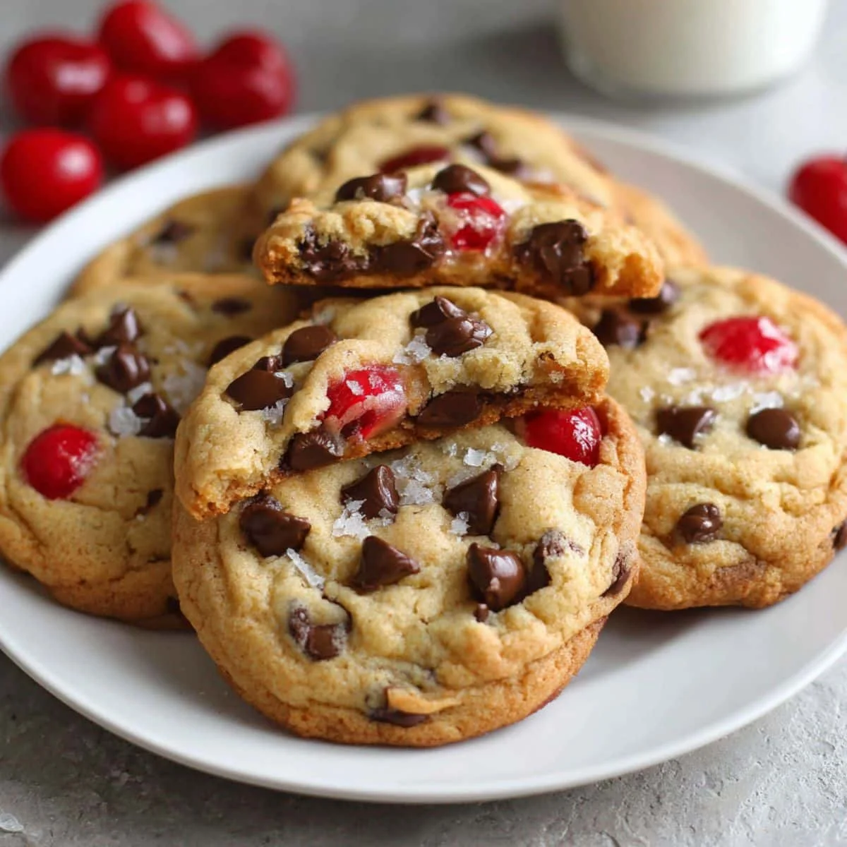 Freshly baked chocolate cherry cookies with melted chocolate chips and cherries  top-down on white kitchen counter