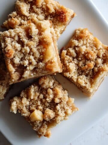 Homemade apple pie bars on a white kitchen counter