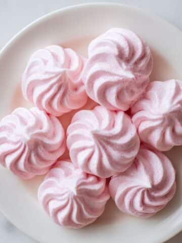 Homemade pink meringue cookies on plate