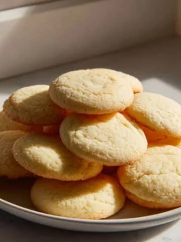 Stack of homemade old fashioned tea cakes on a white kitchen counter
