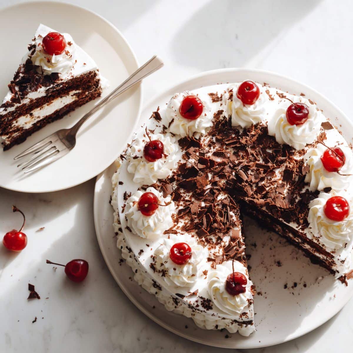 Homemade Black Forest Cake with whipped cream, cherries, and chocolate shavings, with one slice served on a plate.