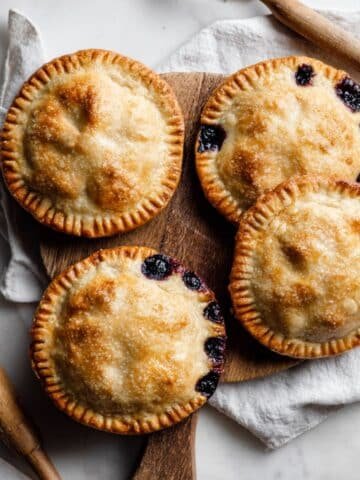 Golden homemade blueberry hand pies recipe on white kitchen counter