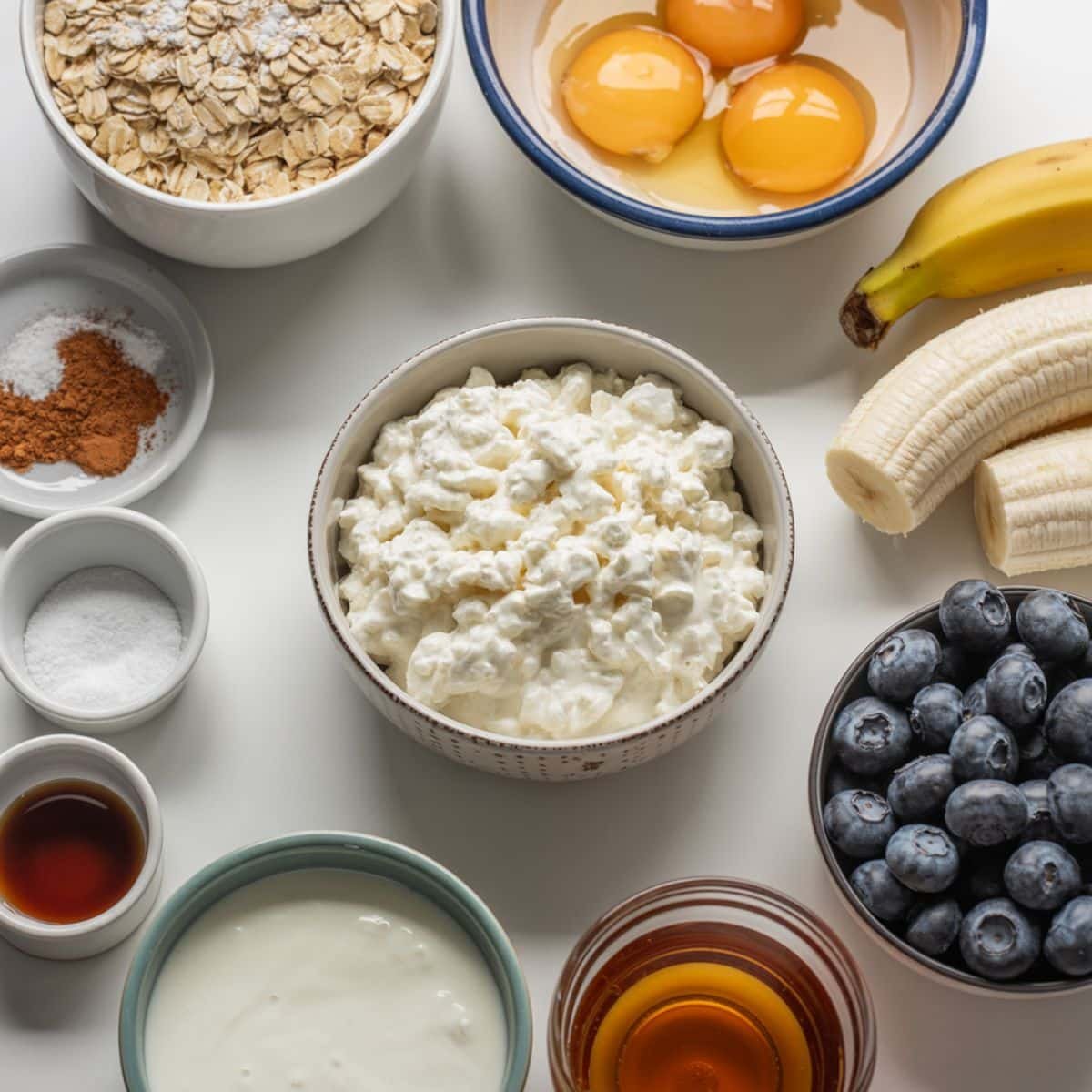 Ingredients for cottage cheese protein pancakes arranged on a white kitchen counter