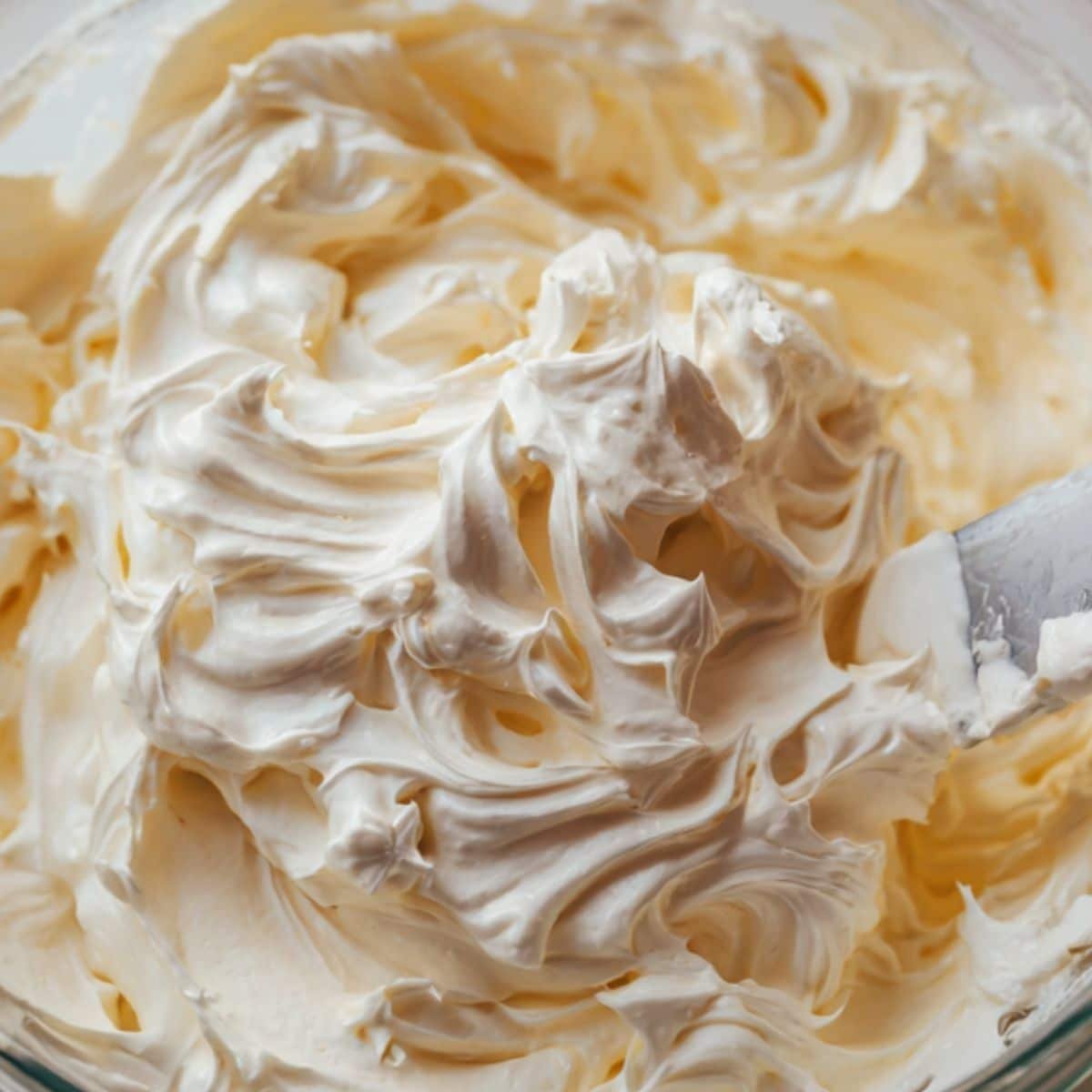 Whipped cream being folded into vanilla pudding	