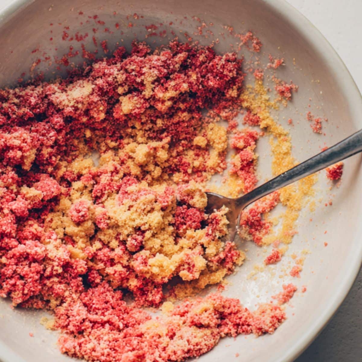 Preparing strawberry crunch topping for cheesecake