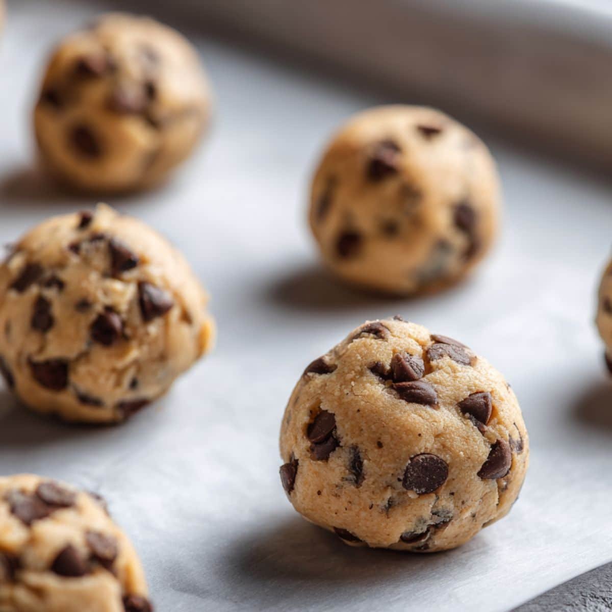 Wrapping cookie dough around Nutella scoops	
