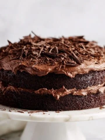 Finished Chocolate Hershey's Cake with creamy frosting and chocolate shavings on marble stand