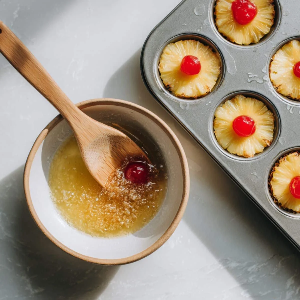 Mixing butter and brown sugar for pineapple cupcake topping