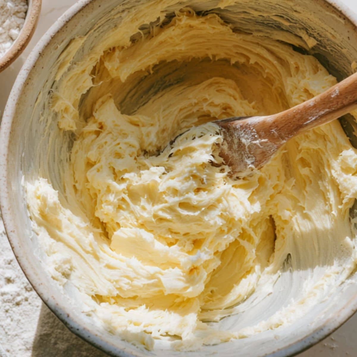 Mixing butter and sugar in a large bowl for old fashioned tea cakes	