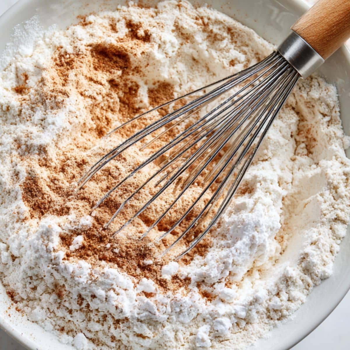 Whisking dry ingredients for pumpkin banana bread in a bowl