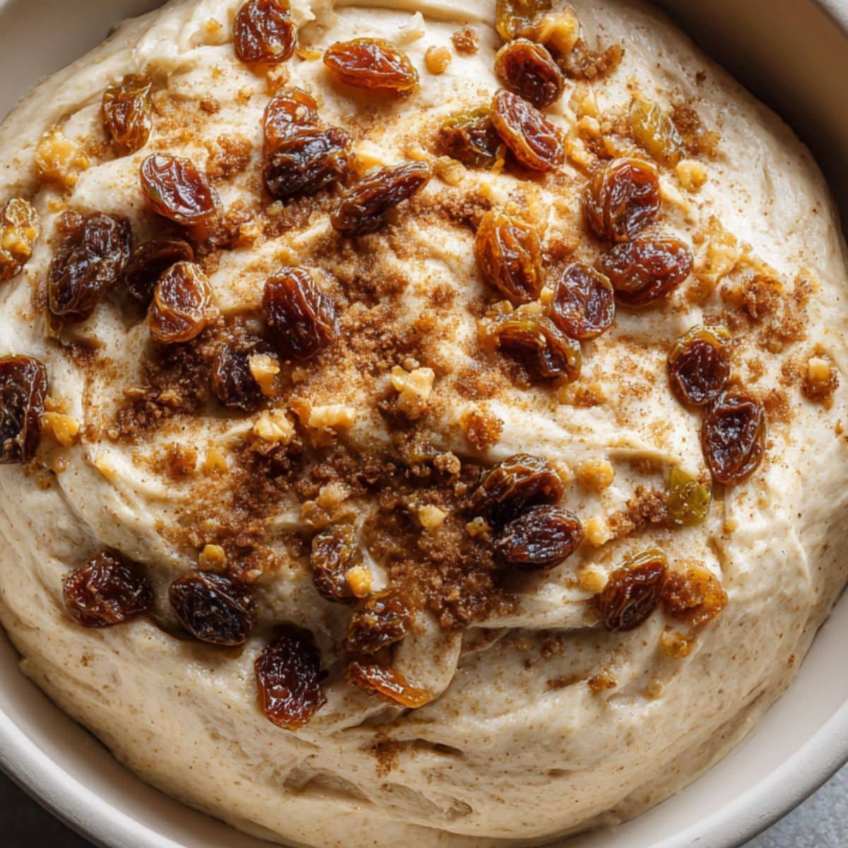 Folding raisins and cinnamon into sourdough dough