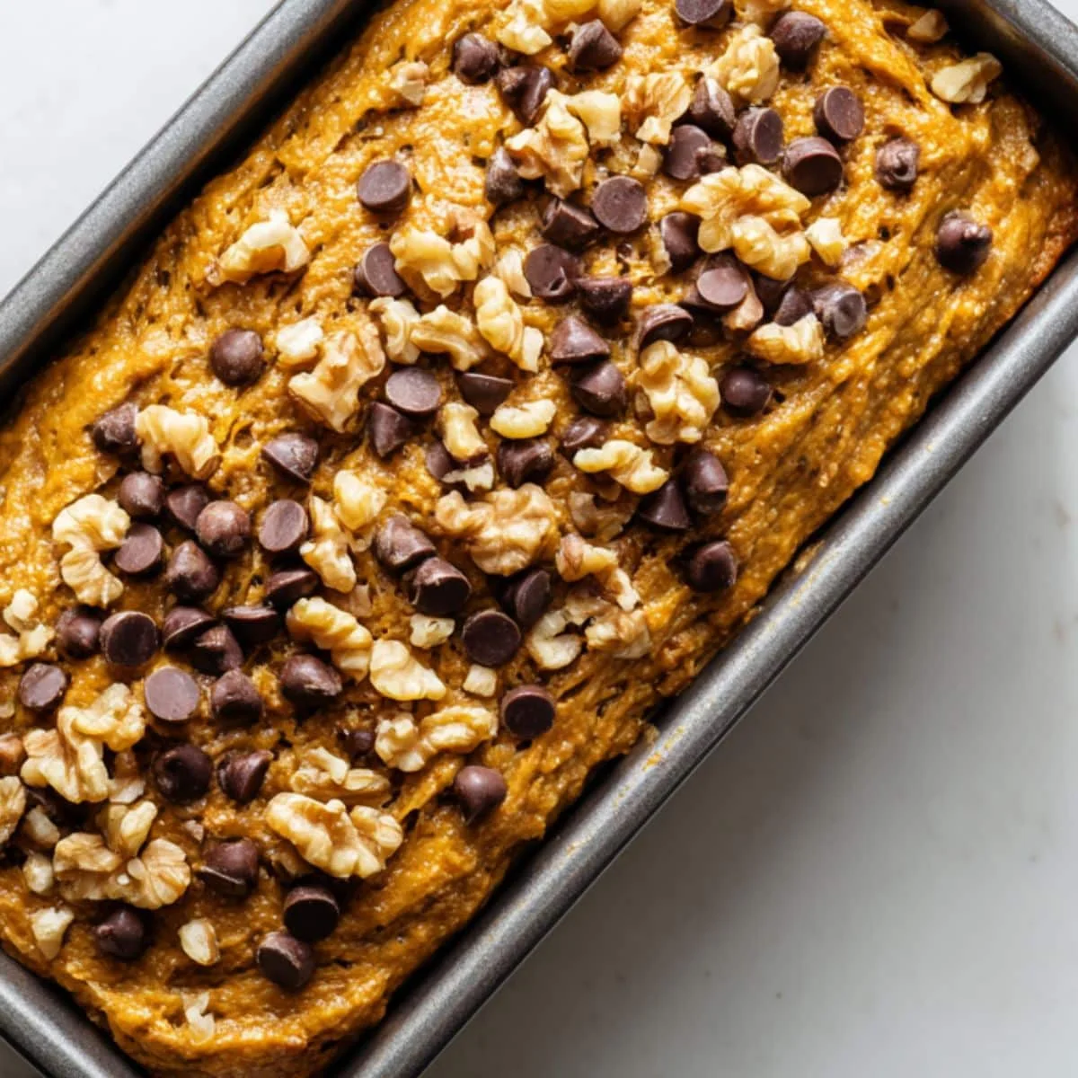 Pumpkin banana bread batter in loaf pan ready for baking