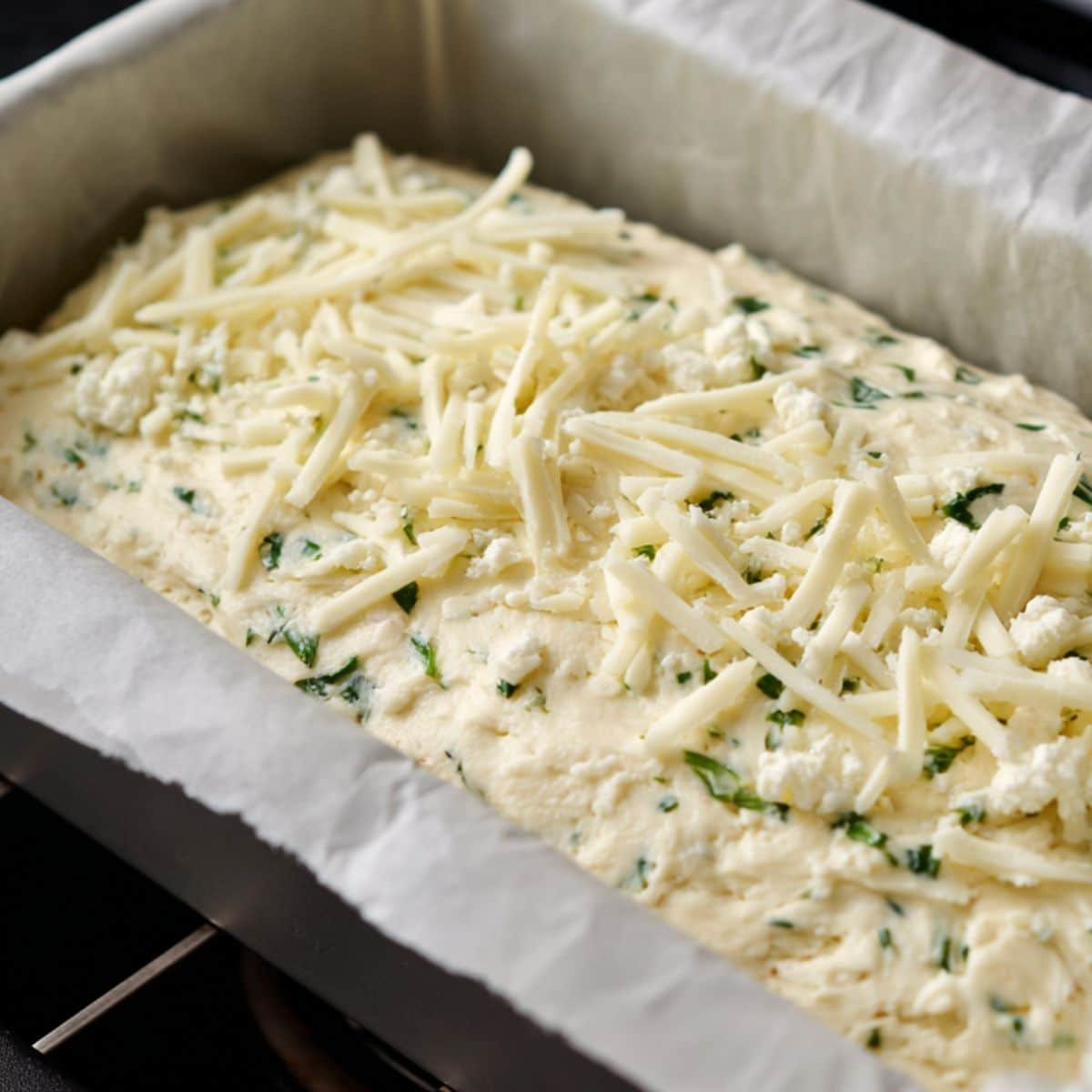 Cottage cheese bread batter ready to bake in a loaf pan
