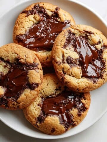 Gooey Nutella stuffed cookie broken open with melted chocolate center