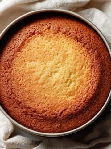 Moist homemade Condensed Milk Cake on a white kitchen table, top-down amateur photo