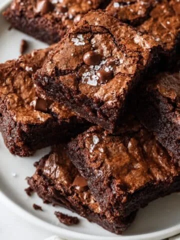 Homemade cake mix brownies cut into squares on a white kitchen table with crumbs scattered, shot from above.