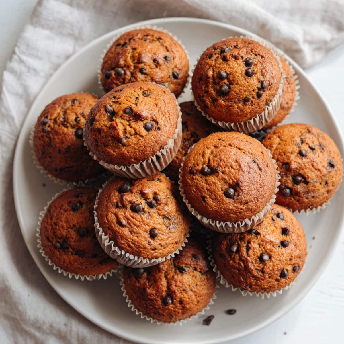 Freshly baked healthy ppumpkin muffins  cooling on a rack, rustic and homemade style.
