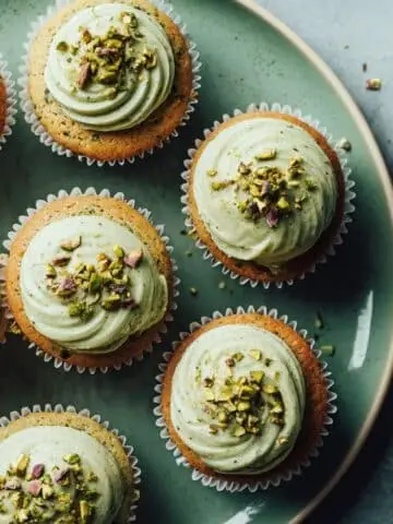 Homemade pistachio cupcakes recipe with frosting and chopped pistachio garnish
