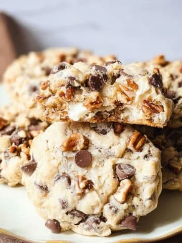 homemade forgotten cookies with chocolate chips on parchment on a white kitchen table.