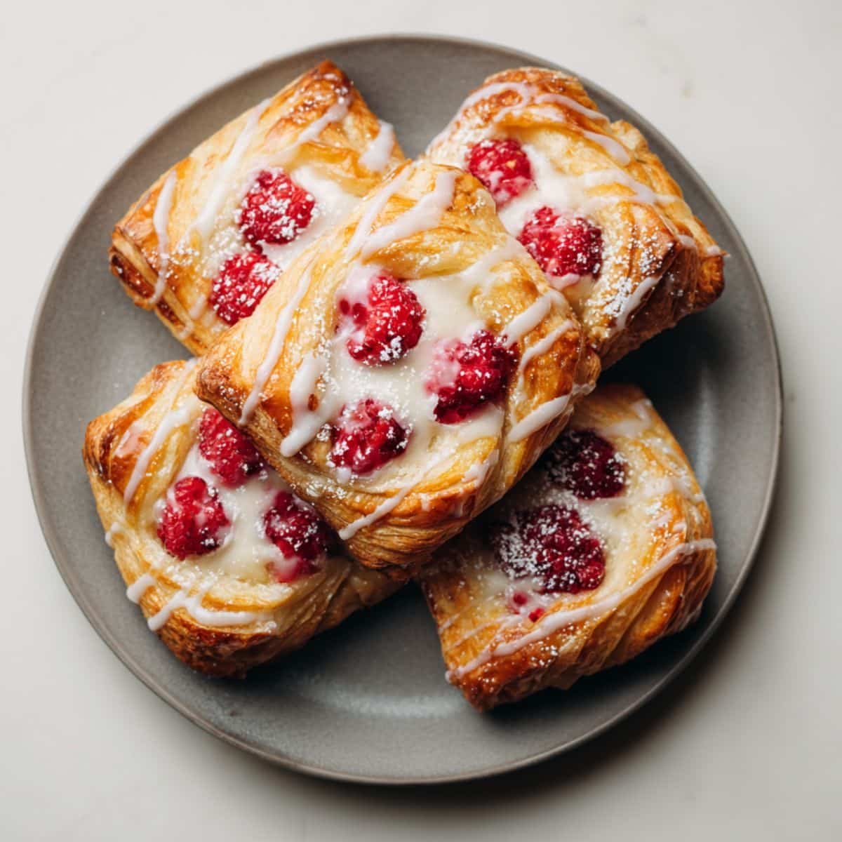Raspberry cream cheese danish pastries with glaze