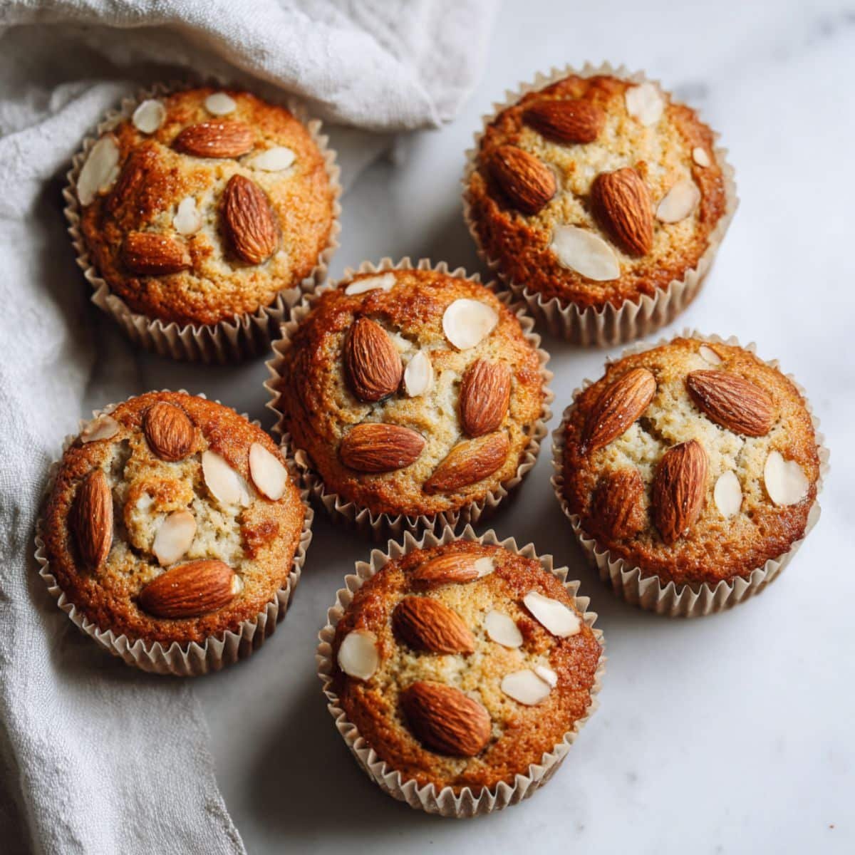 Almond flour muffins freshly baked on a white kitchen counter