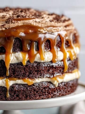 Chocolate caramel cake with gooey caramel filling and rich frosting on a white kitchen counter