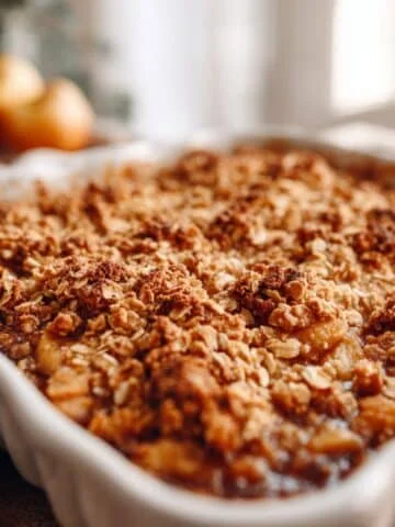 Homemade apple crisp recipe in white kitchen with golden oat topping