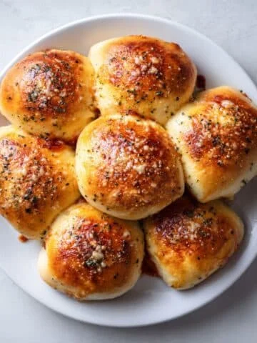 Homemade pepperoni rolls on white kitchen counter with golden crust