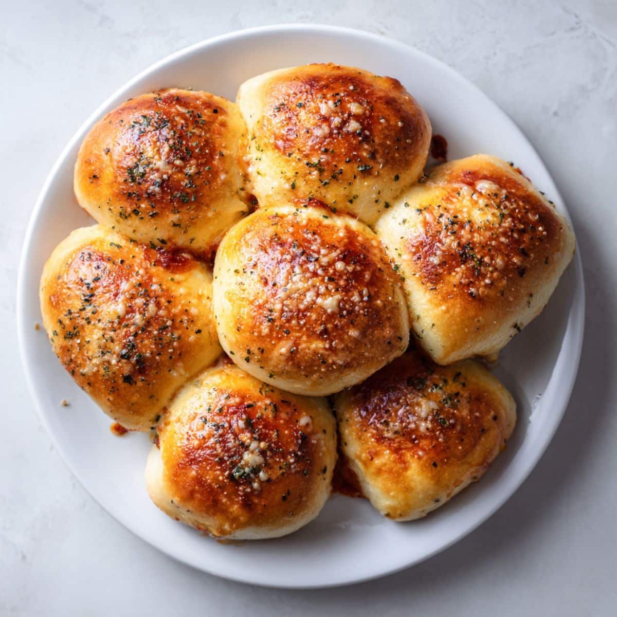Homemade pepperoni rolls recipe on white kitchen counter with golden crust