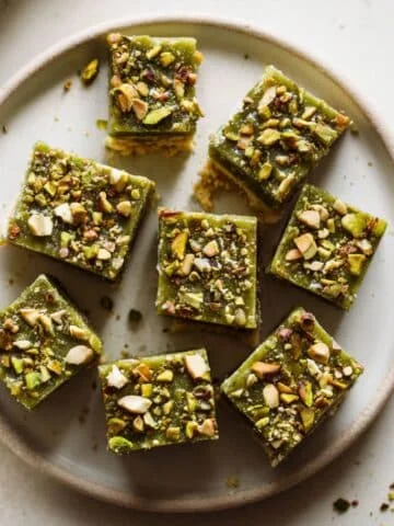 Top-down view of homemade pistachio fudge squares with pistachios on top