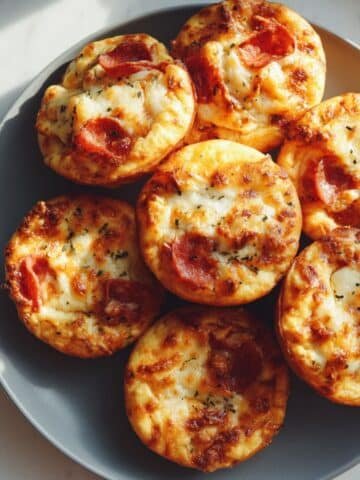 Easy 15-minute pizza muffins with cheese and pepperoni served in muffin tin