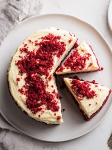 Homemade Cheesecake Factory Red Velvet inspired by Cheesecake Factory, top-down on white kitchen counter