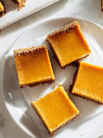 Homemade pumpkin pie bars sliced on a white kitchen table