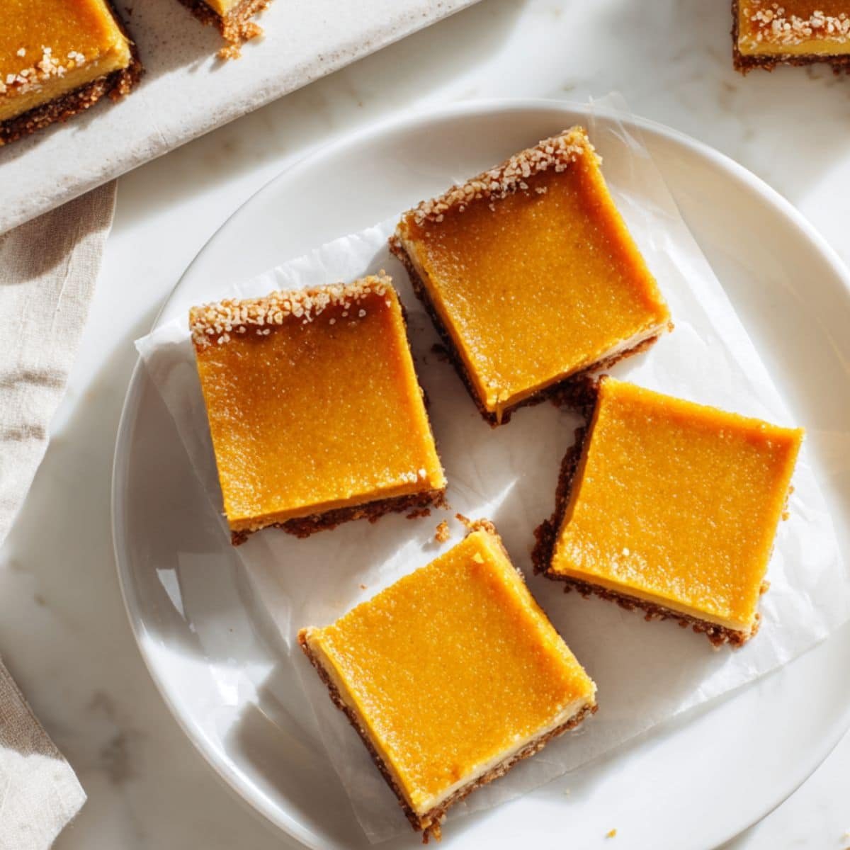Homemade pumpkin pie bars sliced on a white kitchen table