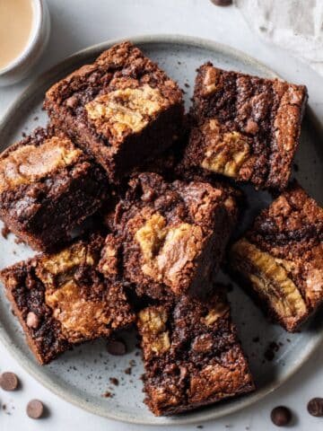 Fudgy banana bread brownies on a white counter.