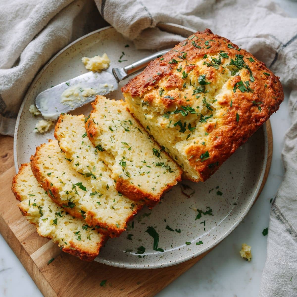 Fluffy homemade keto cottage cheese bread sliced on a white kitchen counter.